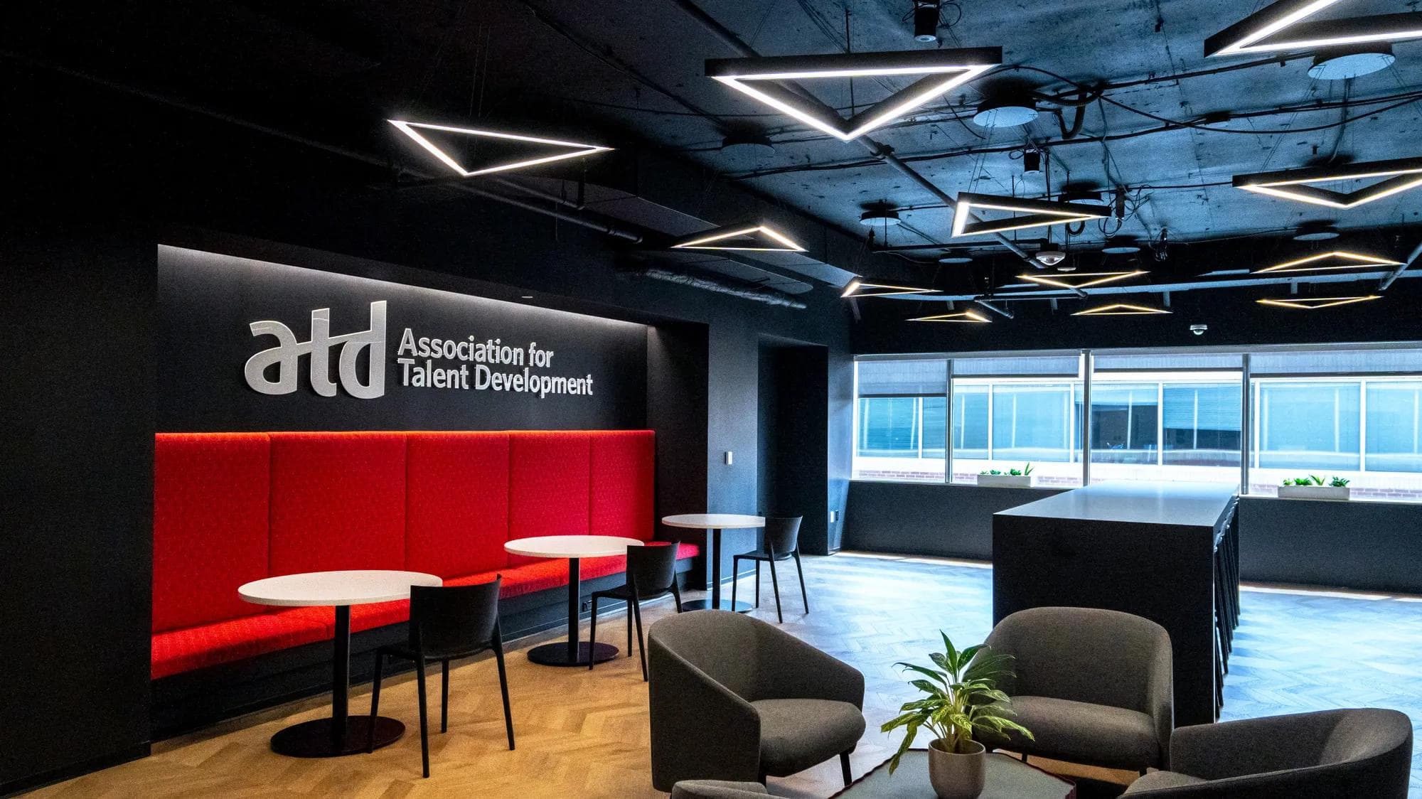 ATD Office cafe area, with a working area and the Association for Talent Development sign and logo on wall