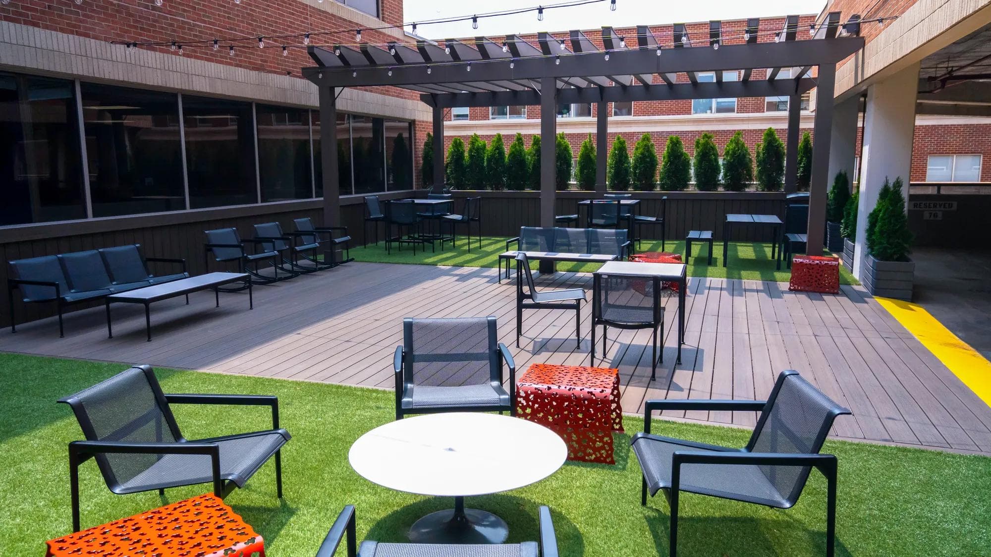 ATD Office outdoor space, showing chairs and tables outdoors in the sun for employees to work.